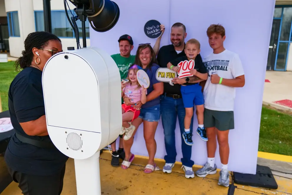 Guests at a photo booth during Leaf River Cellulose Family Day